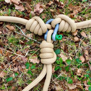 3 large beige coloured ropes tied with a knot to single green-pin shackle