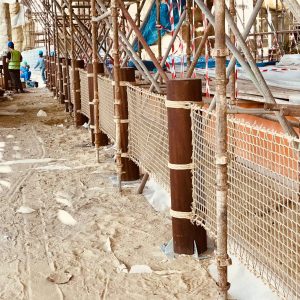 Rope-work Balustrade during installation, between upright round timbers using hemp coloured netting and hemp coloured structural rope.