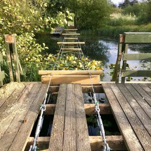 Structural set up for a Rope Bridge over a lake with steel cable, thimbles, ferrules and rigging screws.