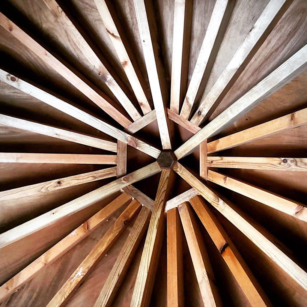 The inside of a hexagonal treehouse roof.