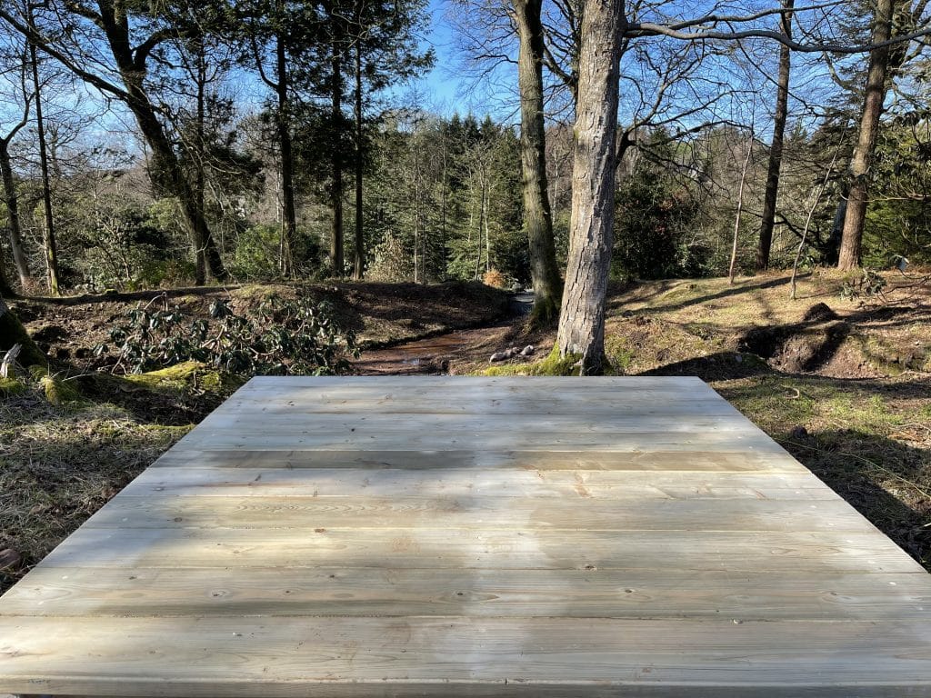 A timber platform that forms part of an outdoor play area at Muncaster Castle.